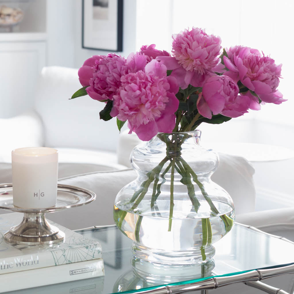 Glass vase with purple flowers