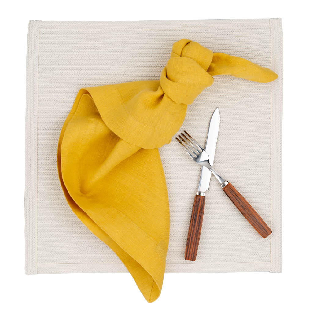 linen placemat with yellow linen napkin