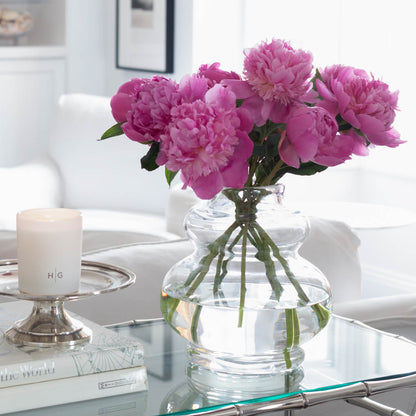 Glass vase with purple flowers 