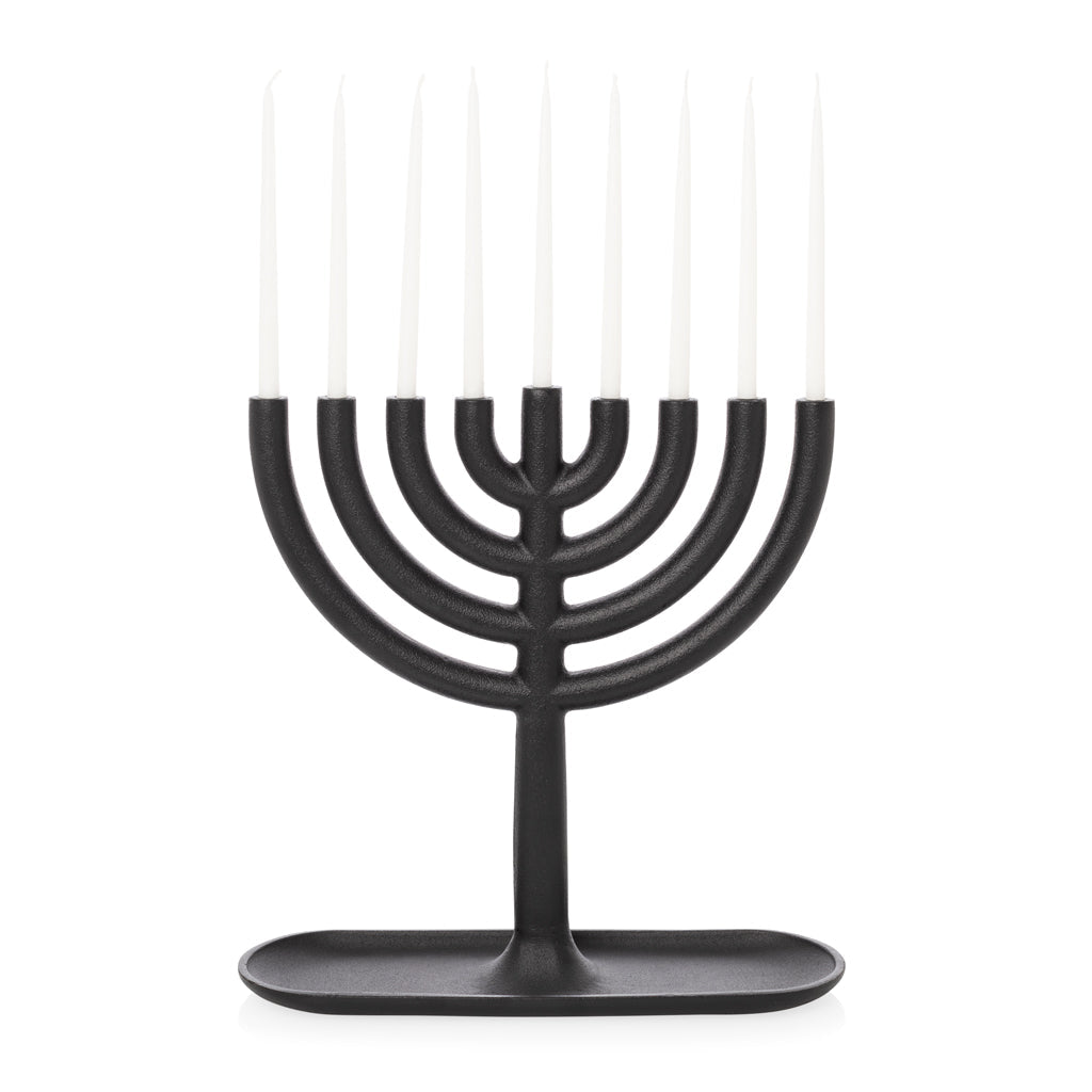 Black cast iron menorah and tiny taper candles