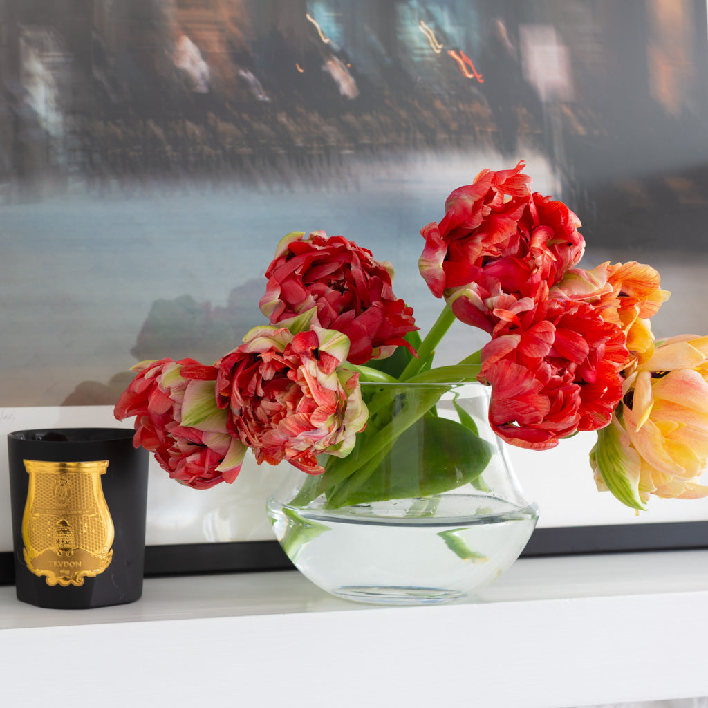 Small glass vase with red flowers